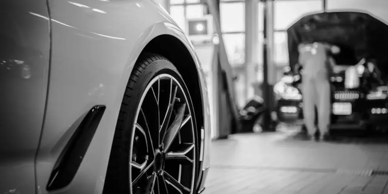 Wniosek o utratę wartości pojazdu wzór. Nowoczesny samochód w warsztacie, mechanik pracuje przy silniku.