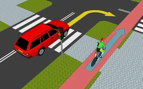 Rowerzysta jedzie ścieżką rowerową, a samochód czeka na zielone światło. Zasada chodnika jest jasna: piesi mają pierwszeństwo na pasach.